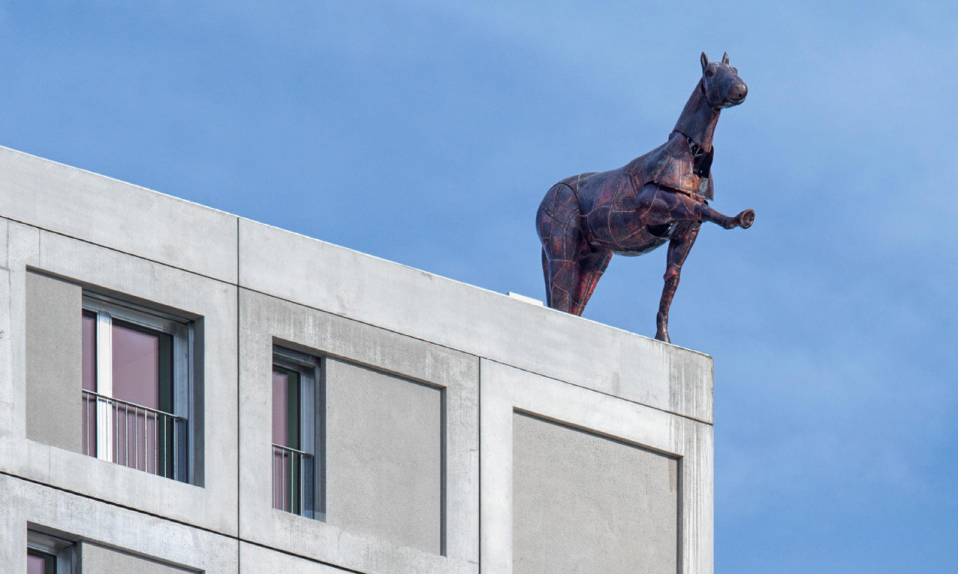Public pavement on Hardturmstrasse facing the rooftop horse at Tramdepot Hard, Hardturmstrasse 8. Stay clear of depot entrances and tram tracks.