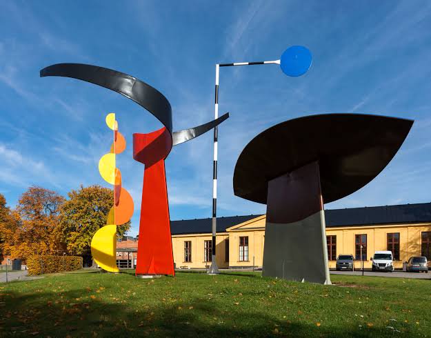 Public paving beside Alexander Calder’s De fyra elementen at Exercisplan on Skeppsholmen. Compare the forms from outside the sculpture; do not climb or move any part.