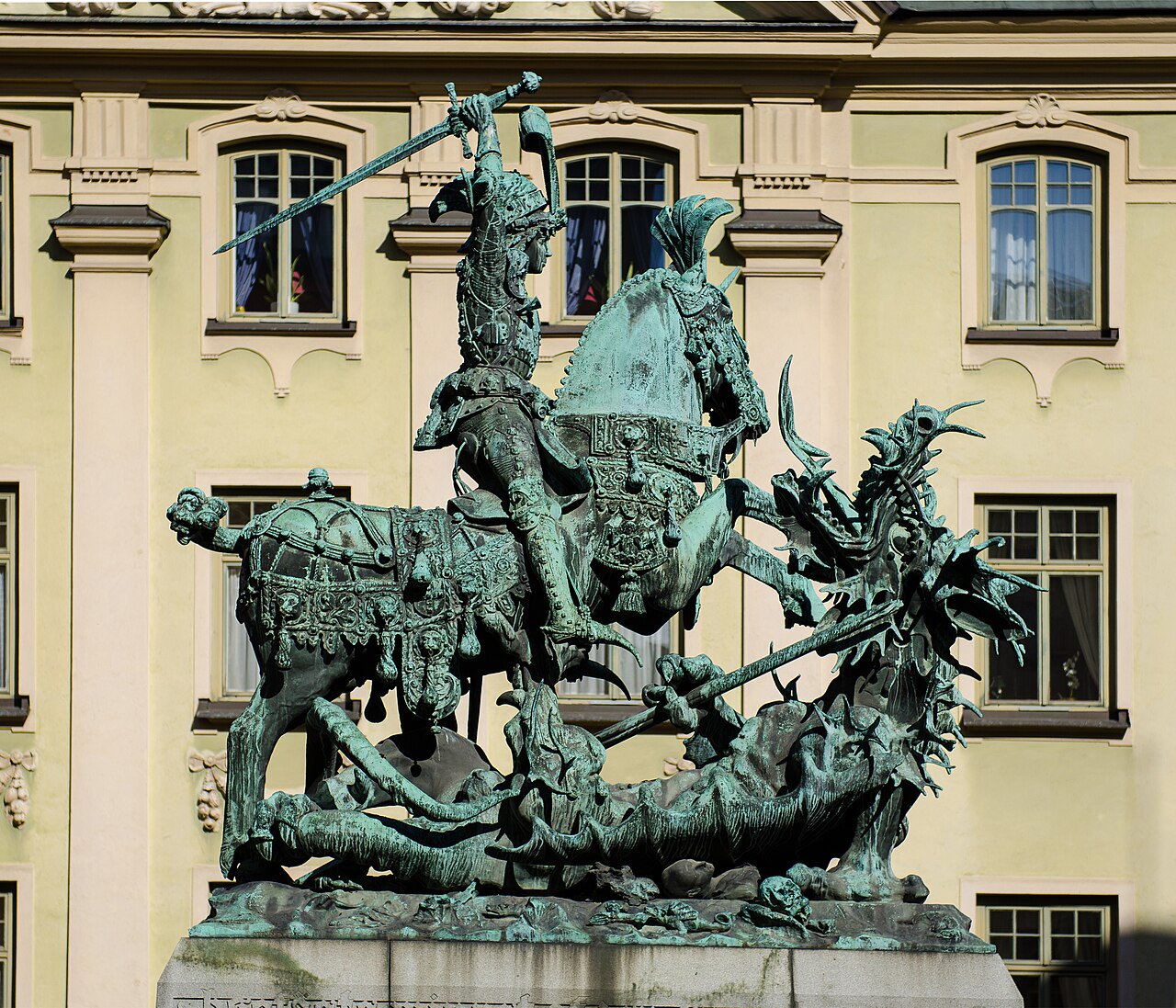 Public paving beside the Saint George and the Dragon sculpture on Köpmantorget. Keep to the square and stay outside the sculpture base.