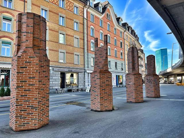 Public pedestrian area facing Towers at Escher-Wyss-Platz, away from tram and road lanes.