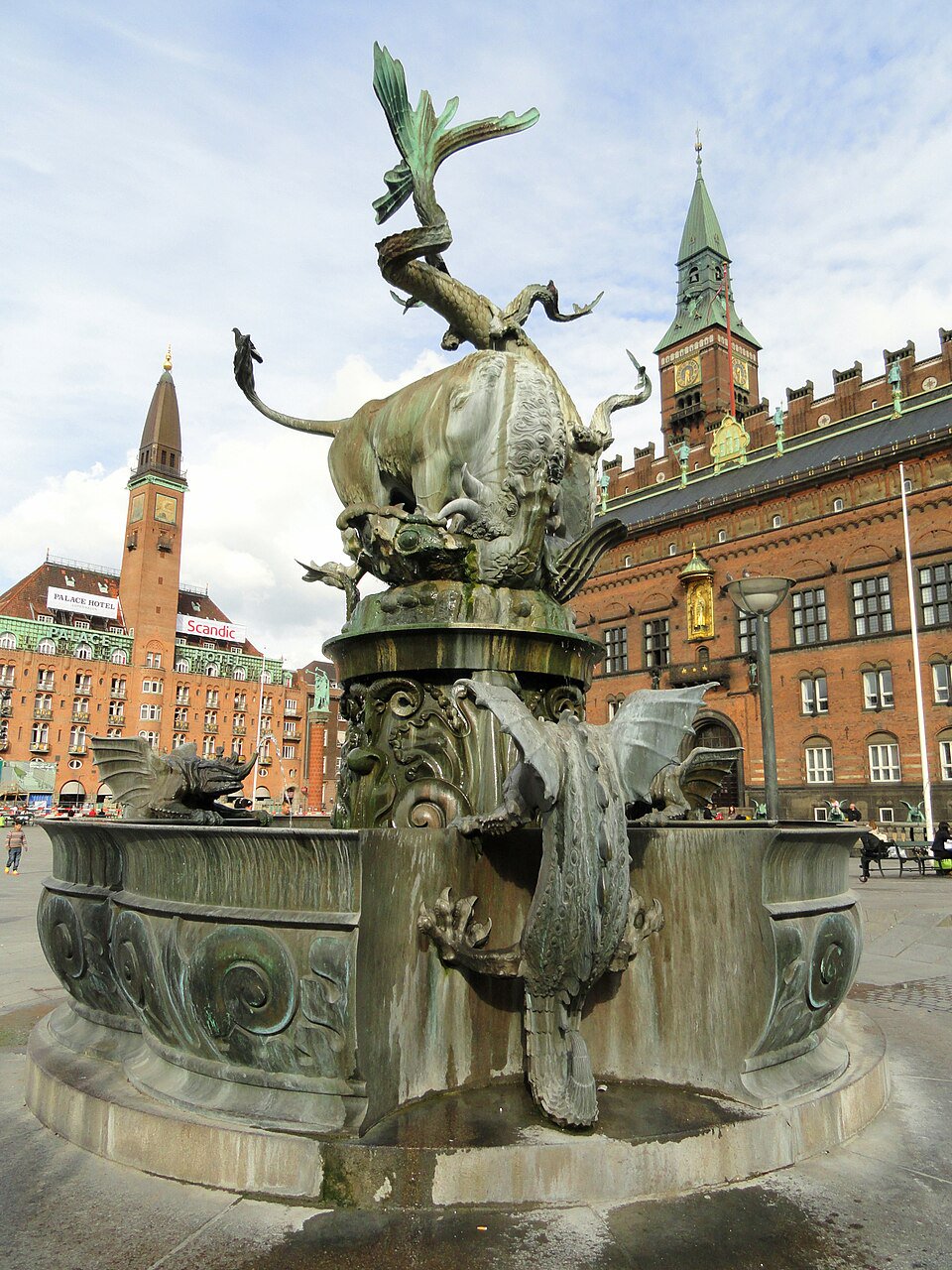 Public paving beside the Dragon Fountain on Rådhuspladsen, outside the basin and clear of pedestrian routes.
