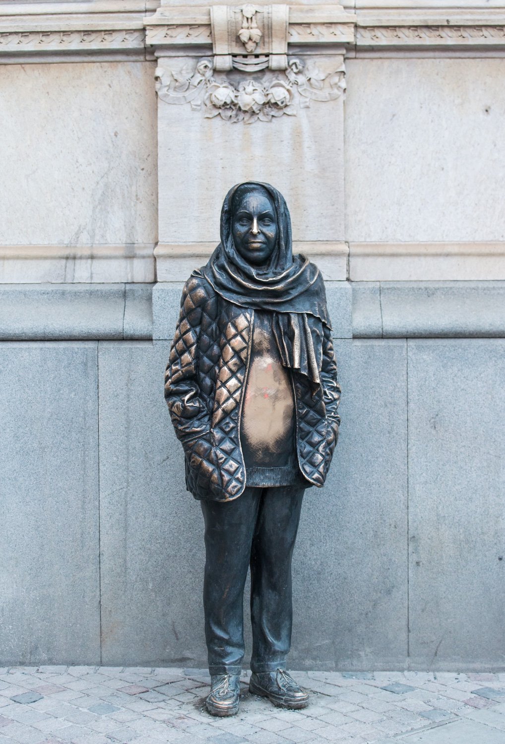 Public pavement beside the Margaretha Krook statue outside Dramaten at Nybroplan; leave the theatre entrance clear.
