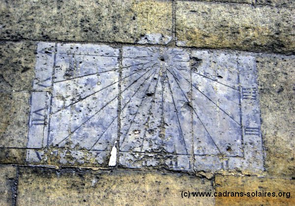 Public pavement along the southern side of Saint-Nicolas-des-Champs on rue Cunin-Gridaine, 75003 Paris. Choose a clear view of a sundial without entering the church.