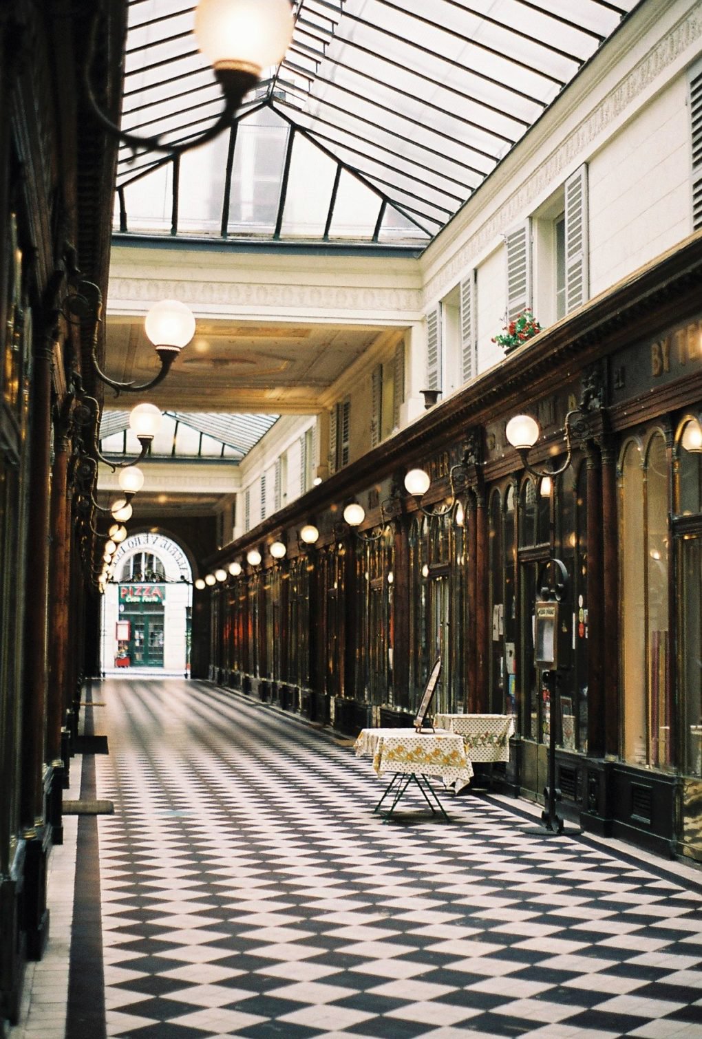 Galerie Véro-Dodat, via 2 rue du Bouloi, 75001 Paris. Stand just inside the open passage, to one side of the pedestrian route.
