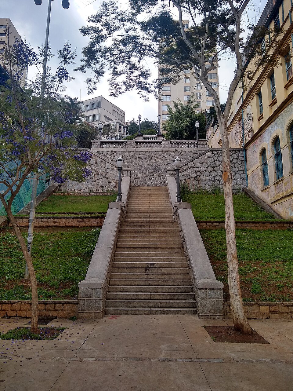 Public pavement at the lower end of Escadaria do Bixiga on Rua Treze de Maio, near Praça Dom Orione, beside rather than on the steps.