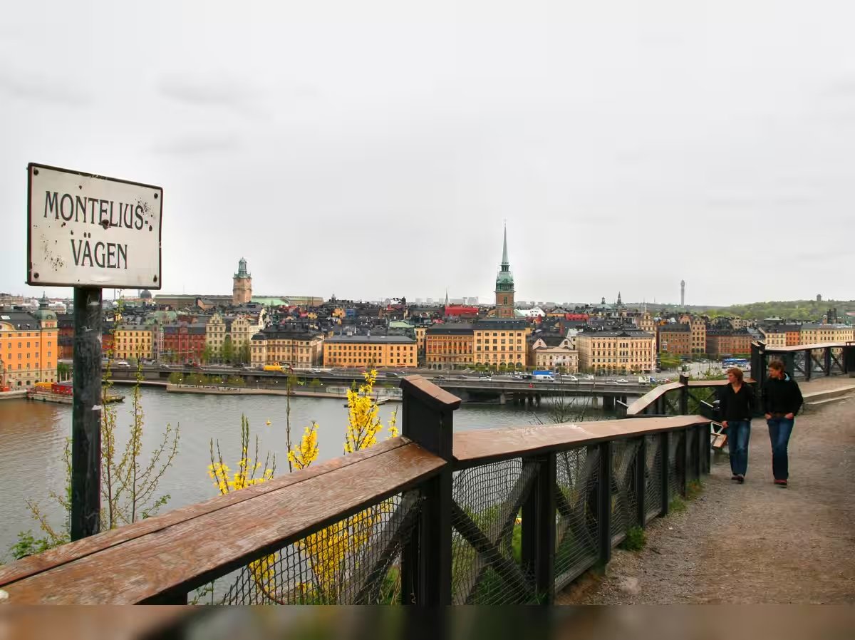Public viewpoint on Monteliusvägen beside the safety railing. Stay on the walking path behind the barrier and leave space for others to pass.