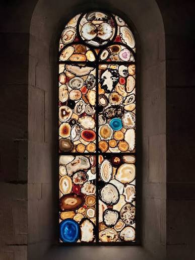 Public visitor area inside Grossmünster with a view of Sigmar Polke’s agate windows, outside service or restricted areas.