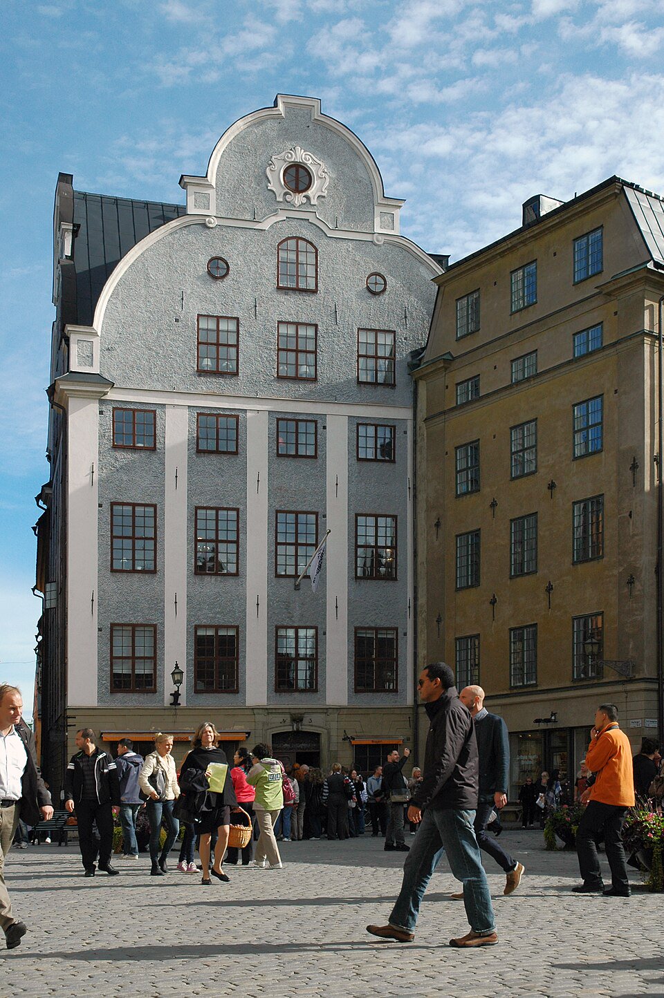 Public paving on Stortorget facing Grillska huset at Stortorget 3. Look across the square at the roofline; no café purchase or entry is needed.