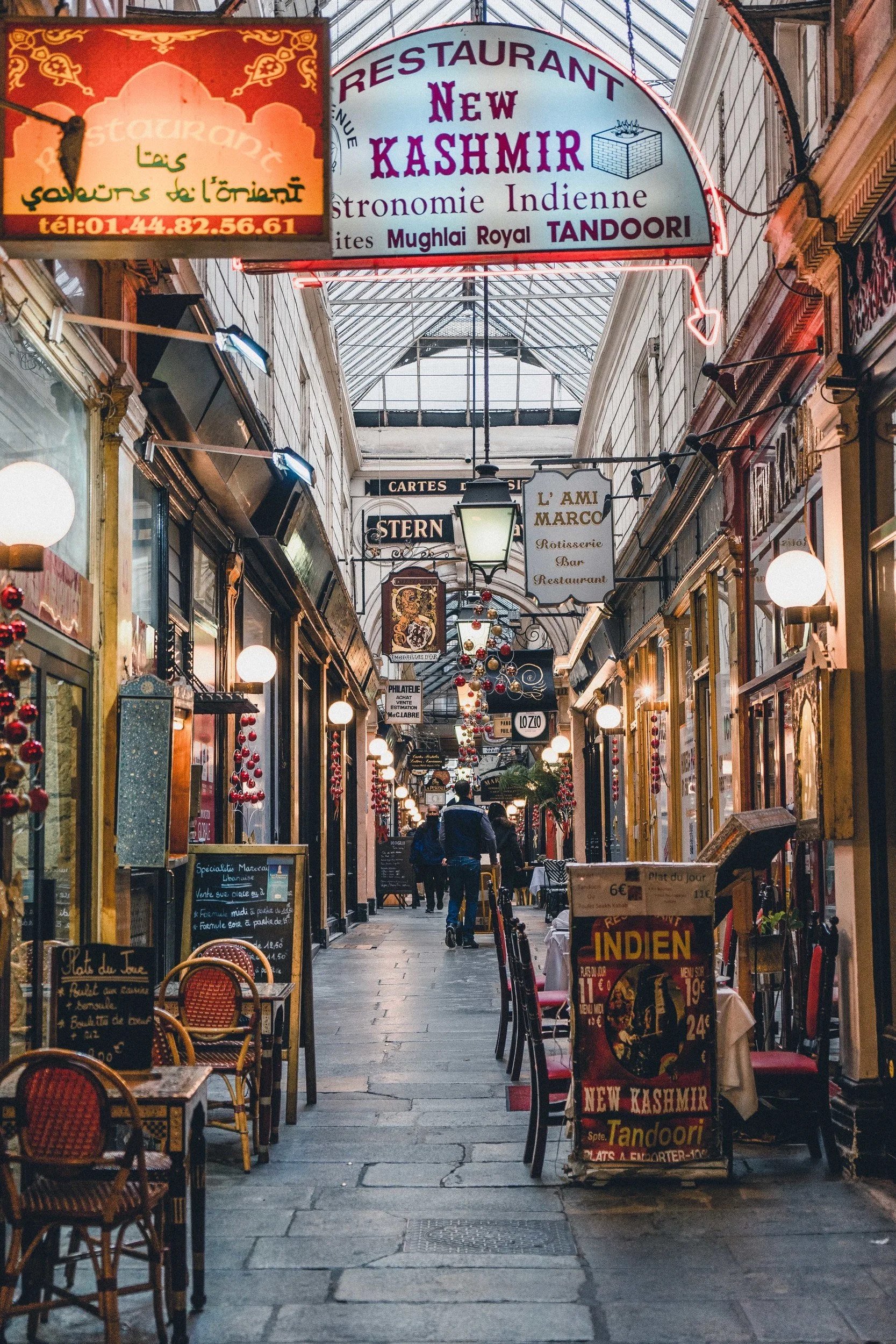 Passage des Panoramas, via 11 boulevard Montmartre, 75002 Paris. Use the shared walking route and stop beside, not in front of, shop entrances.